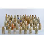 Forty stoneware ginger beer bottles, mostly Birmingham and surrounding areas, some with coloured