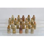 A collection of stoneware Ginger Beer bottles, mostly Birmingham and Black Country manufacturers