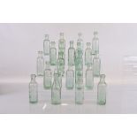 A collection of twenty three flat bottomed beer bottles, by various makers from Dudley,