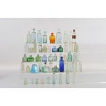 A collection of thirteen 19th century coloured glass ink bottles, of various shapes from conical,