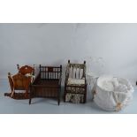 A quantity of doll beds and cots, including a continental rocking crib with painted floral and