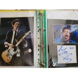 Four A4 yellow folders containing signed photographs and book front pages, including Ronnie Wood,