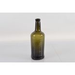 An 18th century hand blown dark green glass wine bottle, with canted flange rim. 26cm tall.