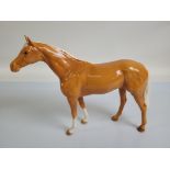 A Beswick model of a palomino horse, 36cm wide x 29cm high