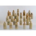 A collection of twenty four stoneware ginger beer bottles, mostly Tipton, Dudley and Walsall.