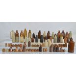 A large collection of stoneware bottles, of various sizes, mostly brown and transparent glazed