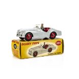 A Dinky Toys 105 Triumph TR2 Sports (Touring Finish), grey body, red interior and hubs, grey driver,