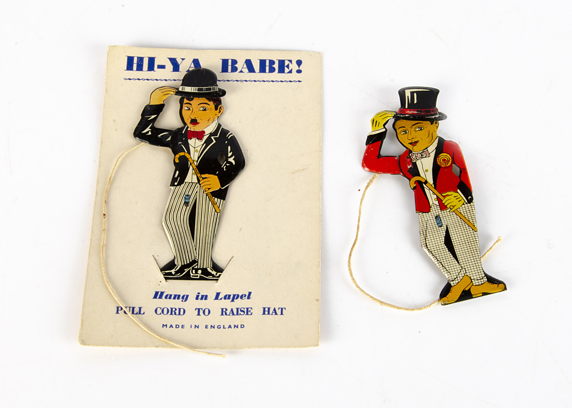 Two Tinplate Lapel 'Greeter' Novelty Toys, one of Charlie Chaplin on original backing card, 'Made in