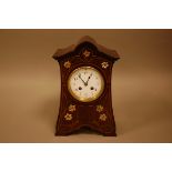 An Art Nouveau period mahogany and inlaid mantle clock, 32cm high, white enamel dial having eight