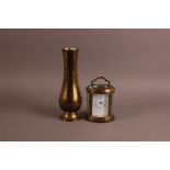 A mid 20th century oval brass carriage timepiece, together with a Middle Eastern brass vase lamp