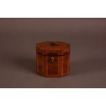 A George III mixed wood tea caddy, octagonal form, later lined, 10cm high and 12cm, with key