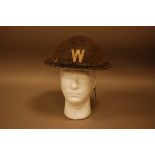 A WWII period Warden's helmet, once black painted with white W to front, leather head lining and