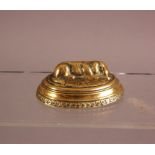 A Victorian brass novelty needle case by Avery & Sons, 8.5cm, modelled as a dog sleeping in its bed,