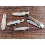 A selection of four assorted combination pocket knives with corkscrews, a bottle shape for Maggi,