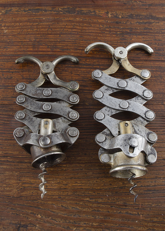 Two French 20th Century concertina corkscrews, patented by Jean Thomas in 1932 with spring mechanism