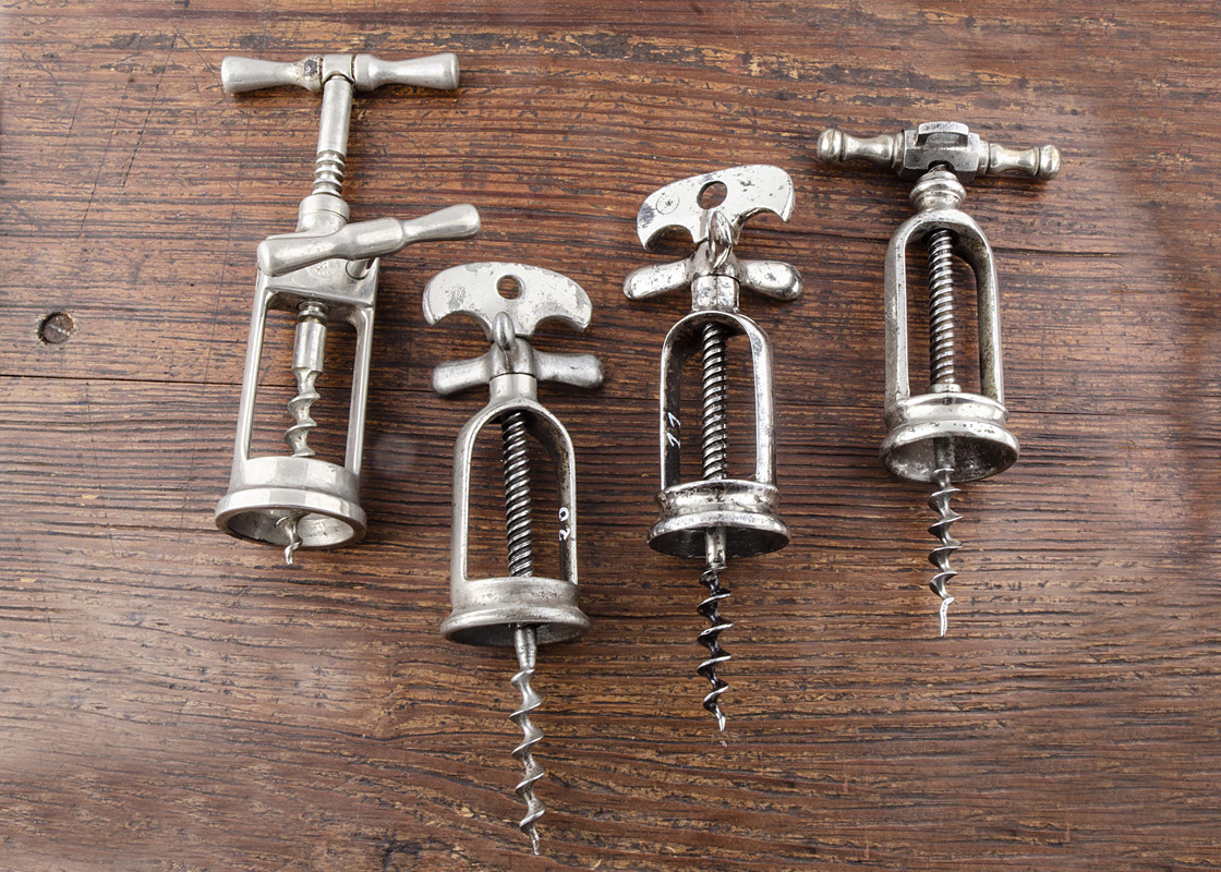 Four French 20th Century all steel mechanical corkscrews, a flip top corkscrew made by Perille, 'A