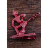 A red painted metal devil corkscrew tail and triangular cap lifter, 8cm x 9cm