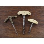 Three French late 19th Century direct pull corkscrews, including a cast vine brass handle and two