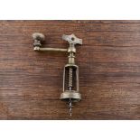 A late 19th Century Italian coffee grinder corkscrew, with wood winding knob, brass open frame and