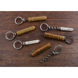 Six advertising one piece of wire corkscrews with sheath protections, the sheaths double up as