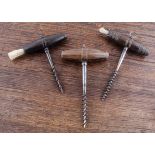 Three English mid to late 19th Century hard wood barrel shape handled straight pull corkscrews, with