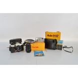 A collection of cameras, including a Praktica MTL 58, a Zeiss Jena DDR 1:3,5 lens, Kodak Easy
