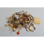 A quantity of costume jewellery, including an early 20th century gold plated curb link bracelet,