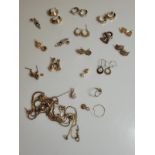 A quantity of assorted 9ct gold, yellow metal rose metal earrings, together with some chains (AF).