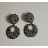 A pair of white metal marcasite drop earrings, both stamped 925.