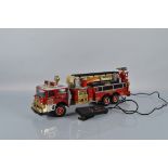 A 1990 battery operated New Bright fire Engine, 68cm long.