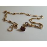 A 15ct gold fetter linked watch chain, with an earlier 19th century carnelian miniature fob,