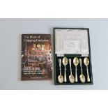 A set of six contemporary silver Guild of Handicrafts teaspoons, contained in a fitted green case,
