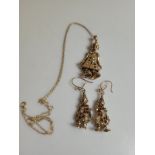 A 9ct gold gem set necklace and earring set, in the form of clowns set with red and clear coloured