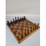 A weighted wooden chess set, with ebonised pieces and wooden board.