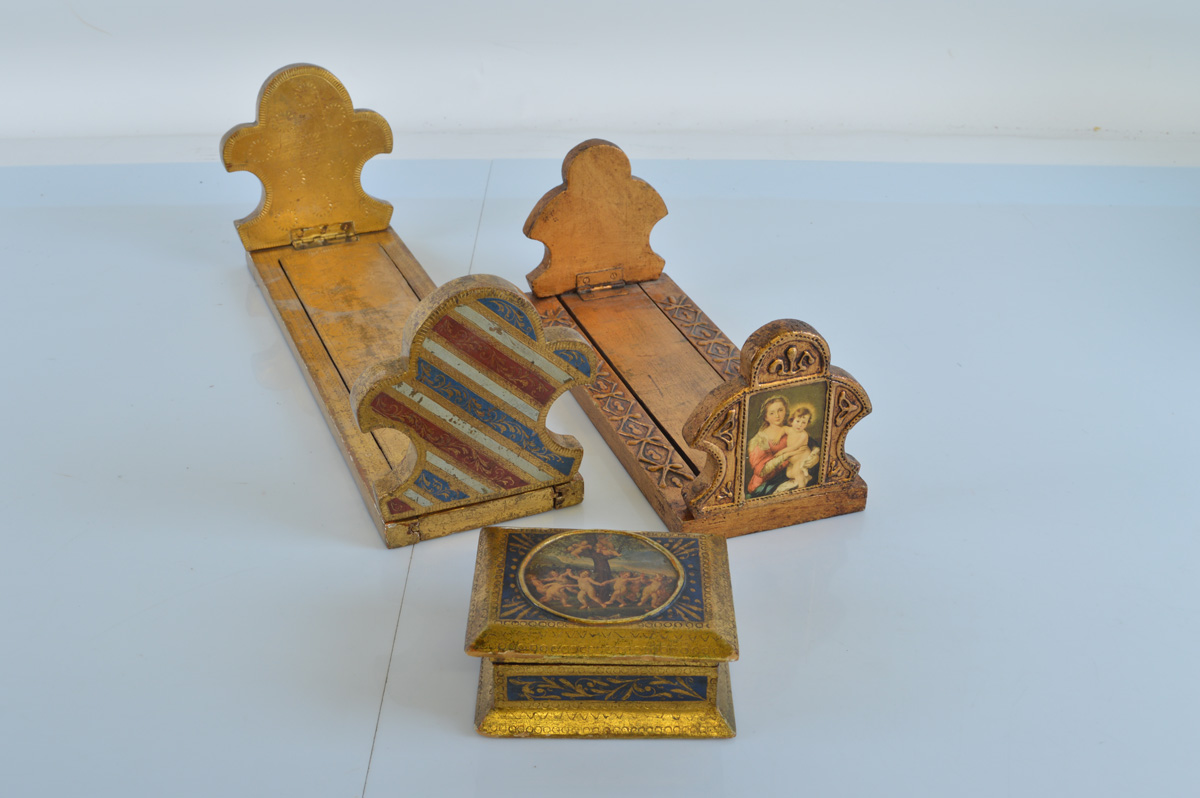 A Continental gilt decorated bookslide with fleur-de-lys style terminals, 38cm long closed. Together