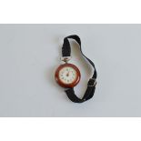 A Continental white metal and enamel ladies trench watch, with white enamel dial and Arabic