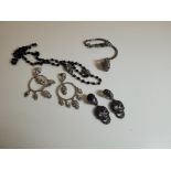 A collection of Butler & Wilson skull jewellery, comprising two sets of earrings, a ring/ bracelet