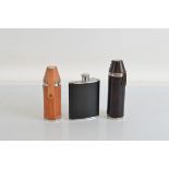 Three stainless steel flasks, all with leather style wrapping, two with four cups each.