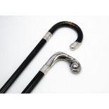 Two vintage walking sticks, one black painted with two silver mounts, the other with white metal