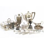 A collection of silver plate, including five butter knives with silver handles, a soup ladle, a