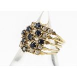 A Middle Eastern blue and colourless sapphire five band yellow metal dress ring, marked 18, ring