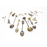 A collection of Australian related pins and souvenir spoons, including a 9ct gold wishbone and