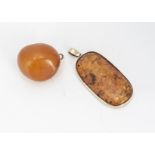 A large amber boulder, mounted with 9ct gold bale, 4cm, together with an amber oval pendant with