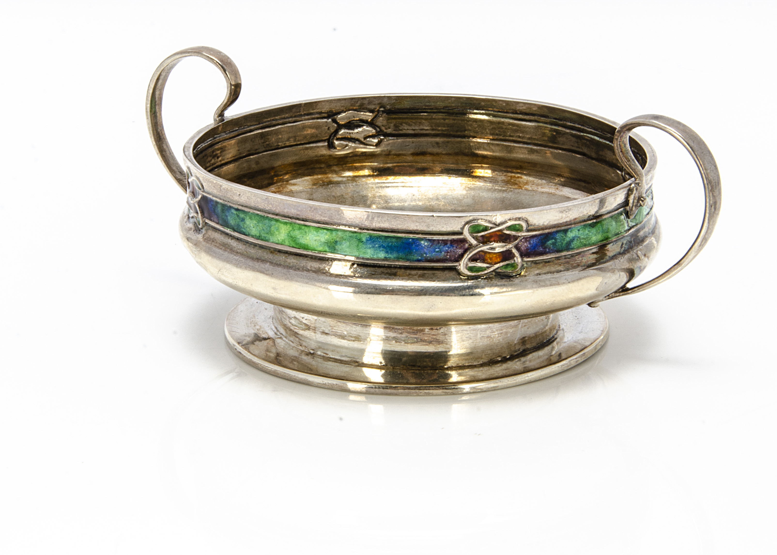 An Edwardian Arts & Crafts silver and enamelled twin handled footed small bowl from Liberty & Co,