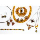 A quantity of amber jewellery, including a tapered disc bead necklace, a silver torque with amber