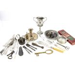 A small group of silver plate and other items, including a brass key, two chambersticks, flatware