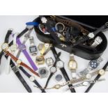 A large collection of fashion watches and related items, including a watch back opener and clamp,