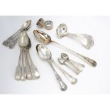 A small collection of silver plated flatware, together with a basting spoon and pair of silver