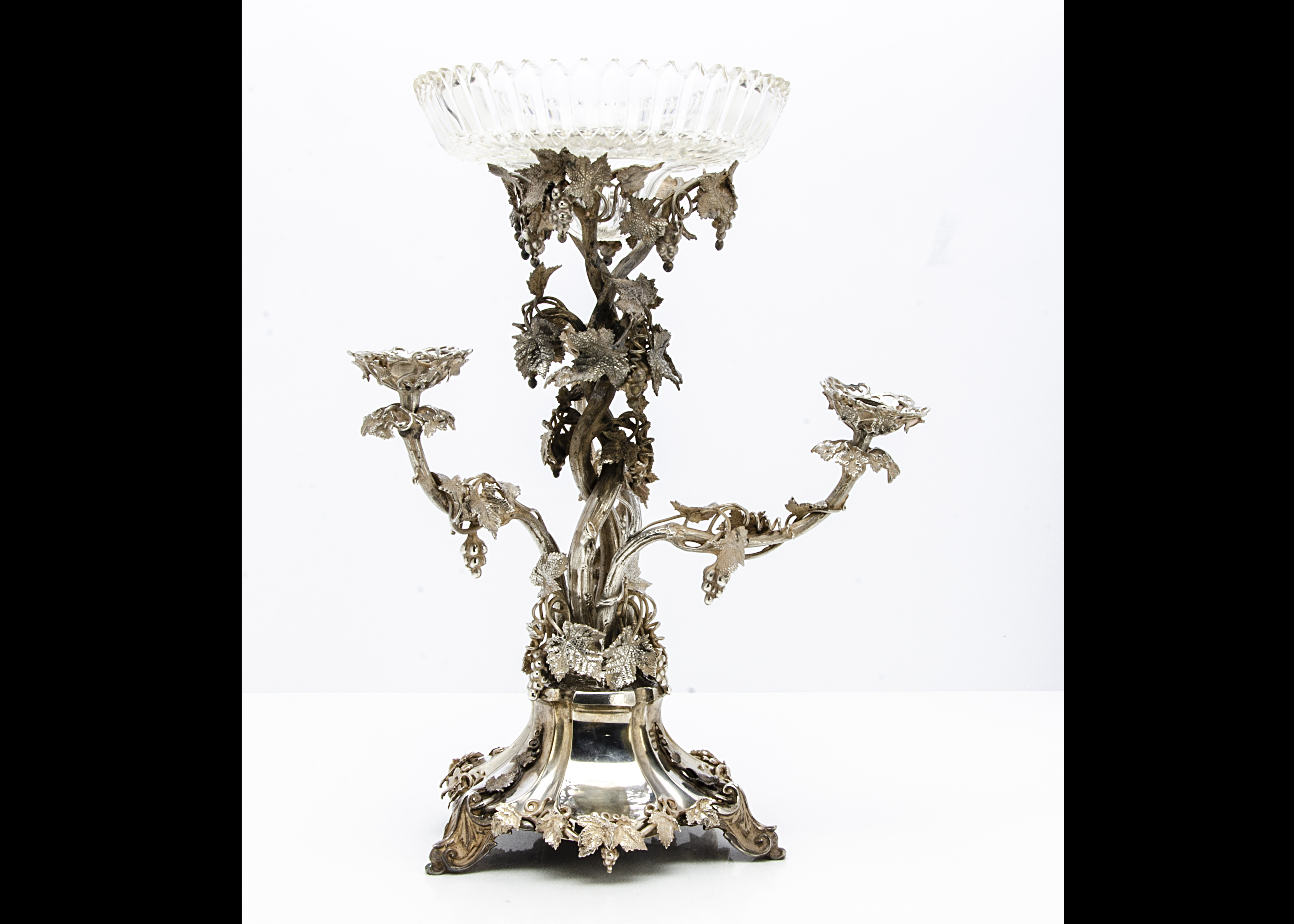 A Victorian silver plated centrepiece, having three inserted branch candle holders and all decorated