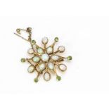 An Edwardian yellow metal precious opal and demantoid garnet star brooch, the twelve pointed star